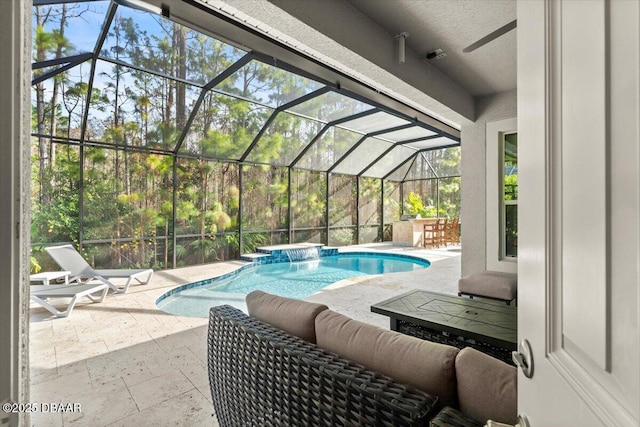 view of pool with pool water feature and a patio