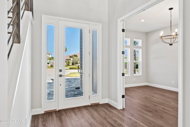 foyer entrance featuring hardwood / wood-style flooring and a notable chandelier