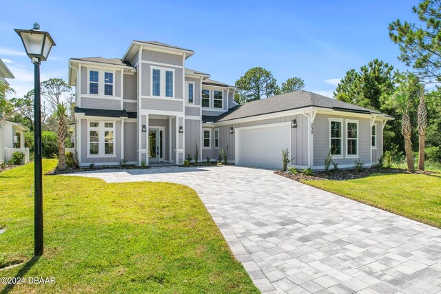 view of front of home featuring a garage and a front yard