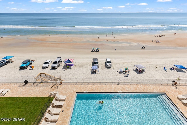 bird's eye view featuring a water view and a beach view