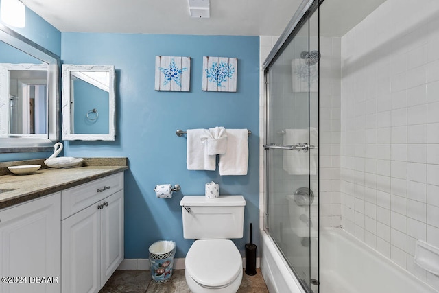 full bathroom featuring vanity, combined bath / shower with glass door, and toilet