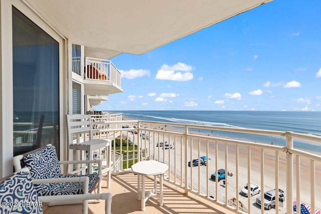 balcony with a water view and a beach view