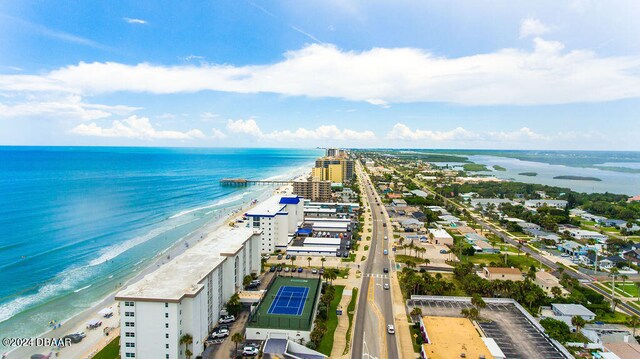 birds eye view of property with a water view and a beach view