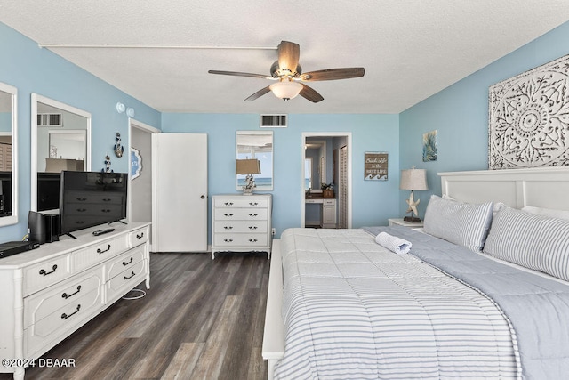 bedroom featuring a textured ceiling, dark wood-type flooring, and ceiling fan