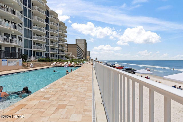 view of pool featuring a water view