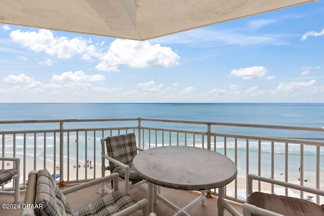 balcony with a beach view and a water view