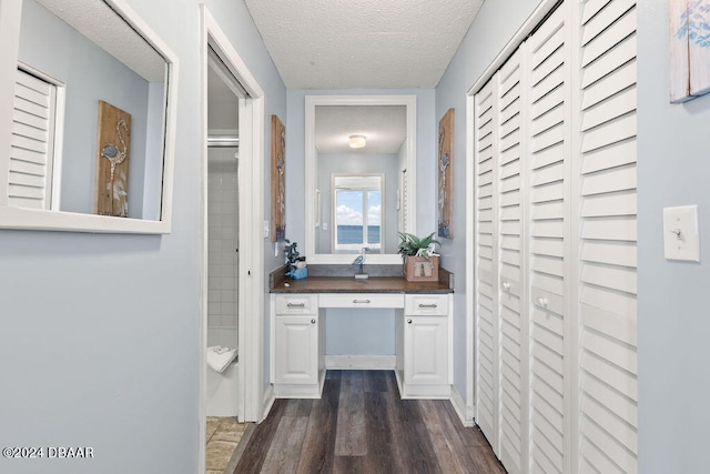 hallway featuring dark hardwood / wood-style flooring and a textured ceiling