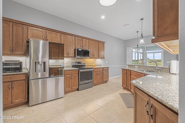 3345 Tesoro Cir, New Smyrna Beach, FL 32168 - kitchen featuring stainless steel appliances, a sink, light tile patterned floors, light stone countertops, and backsplash