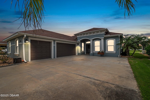 3345 Tesoro Cir, New Smyrna Beach, FL 32168 - view of front of home with stucco siding, an attached garage, and concrete driveway