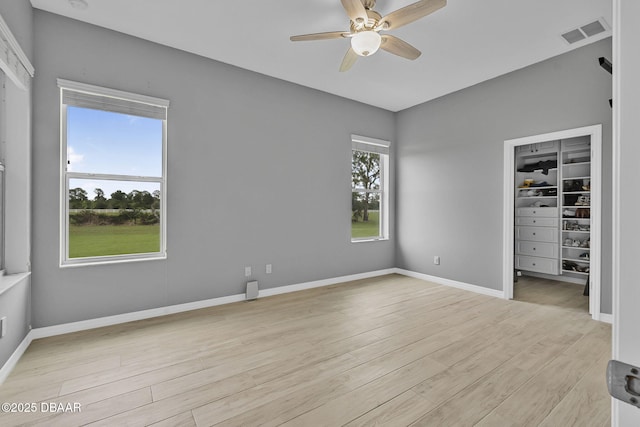 3345 Tesoro Cir, New Smyrna Beach, FL 32168 - unfurnished bedroom featuring light wood-type flooring, a spacious closet, baseboards, and a closet