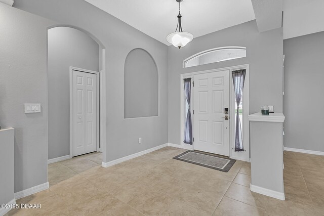 3345 Tesoro Cir, New Smyrna Beach, FL 32168 - entrance foyer with arched walkways, tile patterned flooring, and baseboards