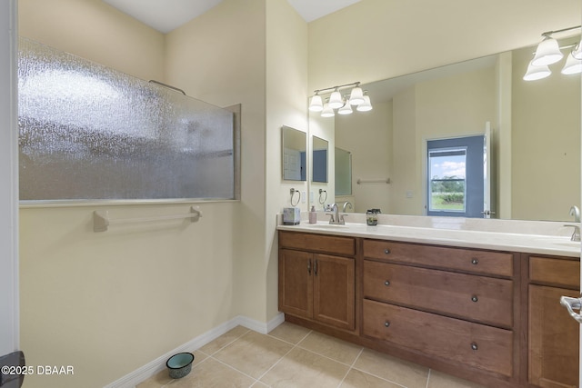 3345 Tesoro Cir, New Smyrna Beach, FL 32168 - bathroom with double vanity, tile patterned flooring, baseboards, a shower, and a chandelier
