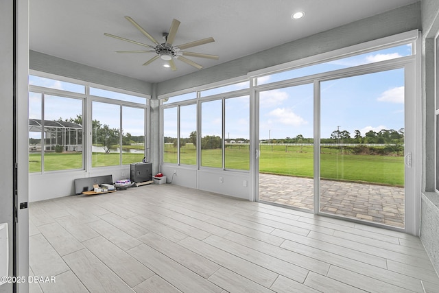3345 Tesoro Cir, New Smyrna Beach, FL 32168 - unfurnished sunroom featuring a ceiling fan and view of golf course