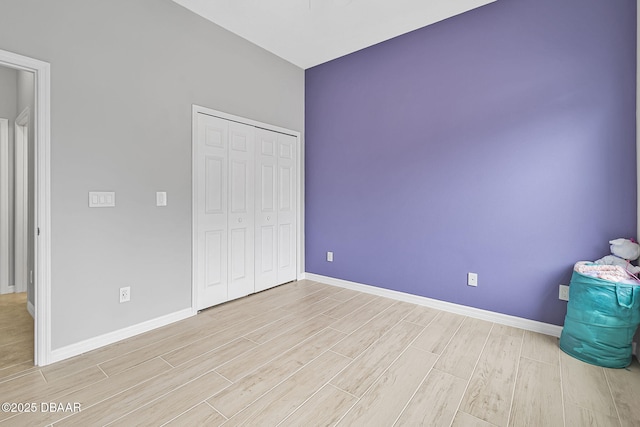 3345 Tesoro Cir, New Smyrna Beach, FL 32168 - unfurnished bedroom featuring light wood-type flooring, baseboards, and a closet