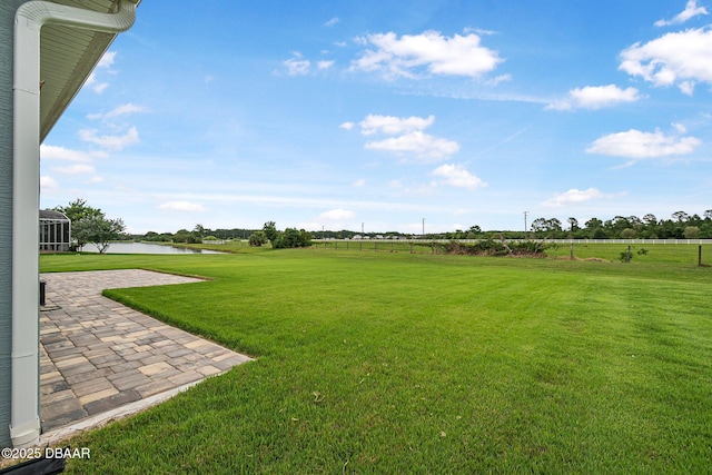 3345 Tesoro Cir, New Smyrna Beach, FL 32168 - view of green lawn featuring a water view and a patio area