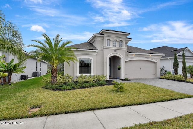 view of front of home with a front yard, a garage, and cooling unit