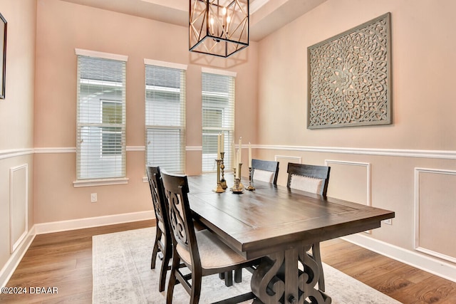 dining room featuring hardwood / wood-style floors and a notable chandelier