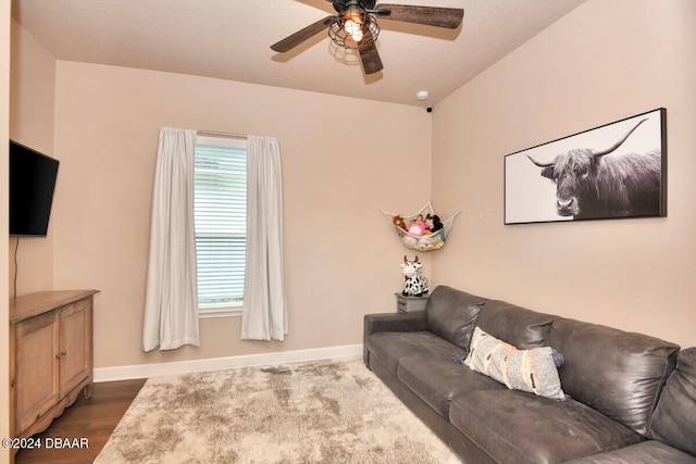 living room with dark hardwood / wood-style floors and ceiling fan