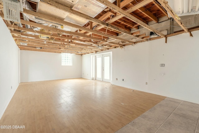 spare room featuring wood finished floors and french doors