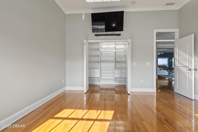 4210 S Peninsula Dr, Port Orange, FL 32127 - unfurnished bedroom with ornamental molding, wood finished floors, baseboards, and a closet
