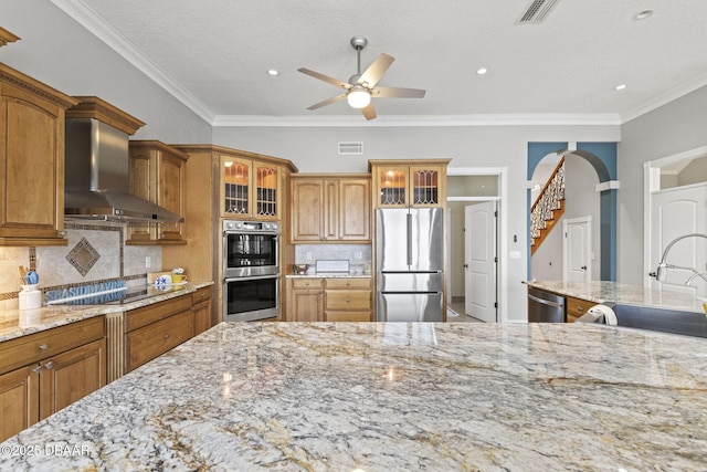 4210 S Peninsula Dr, Port Orange, FL 32127 - kitchen featuring stainless steel appliances, wall chimney range hood, a sink, ceiling fan, and light stone countertops