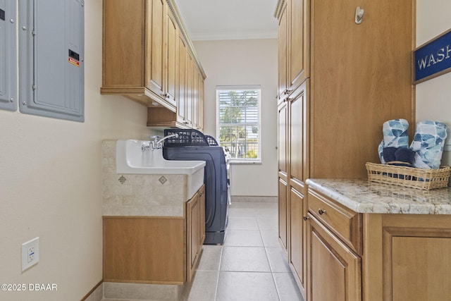 4210 S Peninsula Dr, Port Orange, FL 32127 - laundry room with cabinet space, electric panel, crown molding, baseboards, and light tile patterned flooring