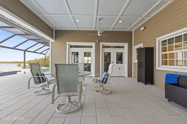 4210 S Peninsula Dr, Port Orange, FL 32127 - view of patio / terrace with french doors, glass enclosure, a water view, and outdoor dining space