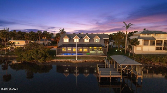 4210 S Peninsula Dr, Port Orange, FL 32127 - back of house at dusk featuring boat lift, a pool, and a water view