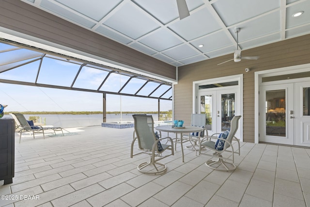 4210 S Peninsula Dr, Port Orange, FL 32127 - view of patio / terrace with french doors, a water view, glass enclosure, and a pool with connected hot tub