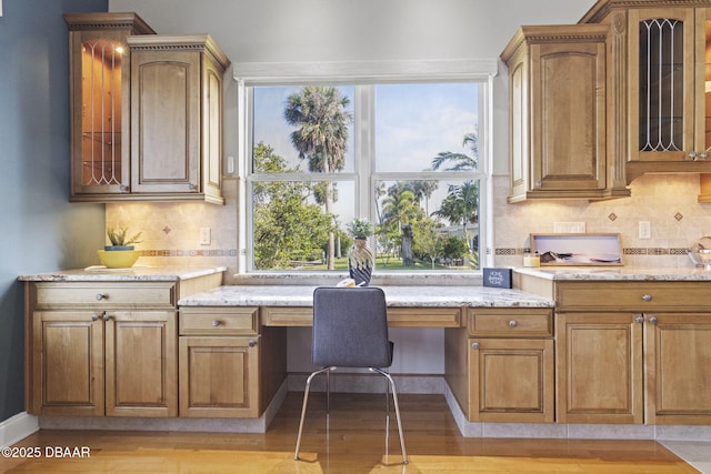 4210 S Peninsula Dr, Port Orange, FL 32127 - home office featuring built in study area, light wood-style floors, and plenty of natural light