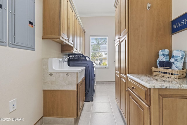 4210 S Peninsula Dr, Port Orange, FL 32127 - laundry area with cabinet space, electric panel, ornamental molding, baseboards, and light tile patterned floors