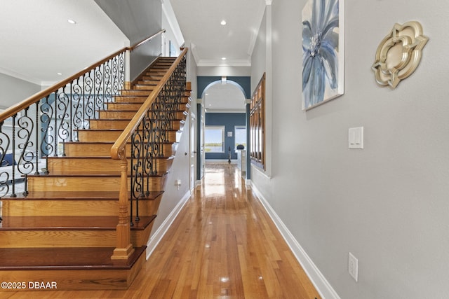 4210 S Peninsula Dr, Port Orange, FL 32127 - stairs featuring crown molding, hardwood / wood-style flooring, baseboards, recessed lighting, and arched walkways
