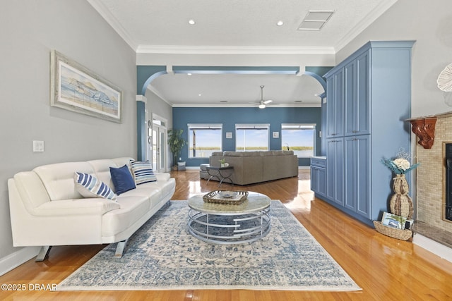 4210 S Peninsula Dr, Port Orange, FL 32127 - living area with arched walkways, wood finished floors, a glass covered fireplace, and recessed lighting
