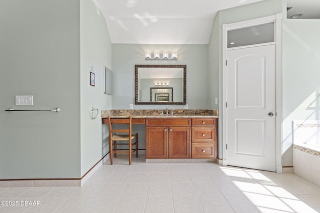 4210 S Peninsula Dr, Port Orange, FL 32127 - bathroom with vanity, tiled bath, tile patterned floors, and baseboards