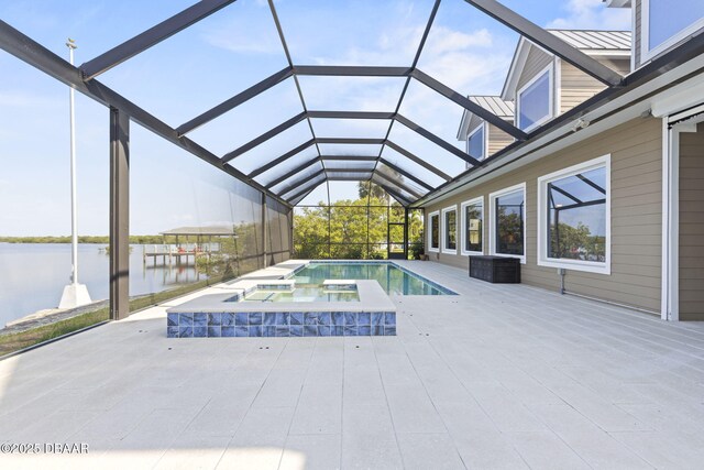 4210 S Peninsula Dr, Port Orange, FL 32127 - view of swimming pool with a water view, a lanai, a pool with connected hot tub, and a patio