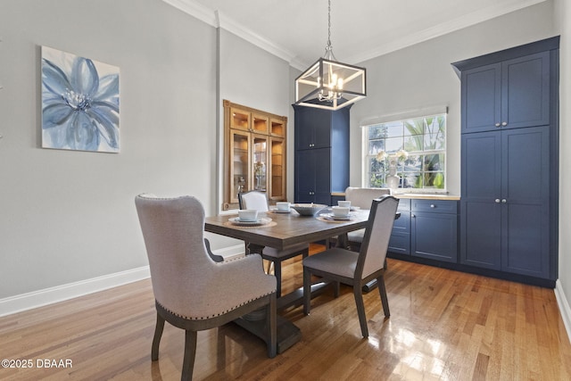 4210 S Peninsula Dr, Port Orange, FL 32127 - dining area with a chandelier, light wood finished floors, crown molding, and baseboards