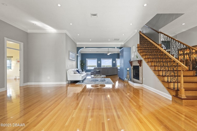 4210 S Peninsula Dr, Port Orange, FL 32127 - living area featuring a fireplace with raised hearth, wood finished floors, a ceiling fan, stairway, and recessed lighting