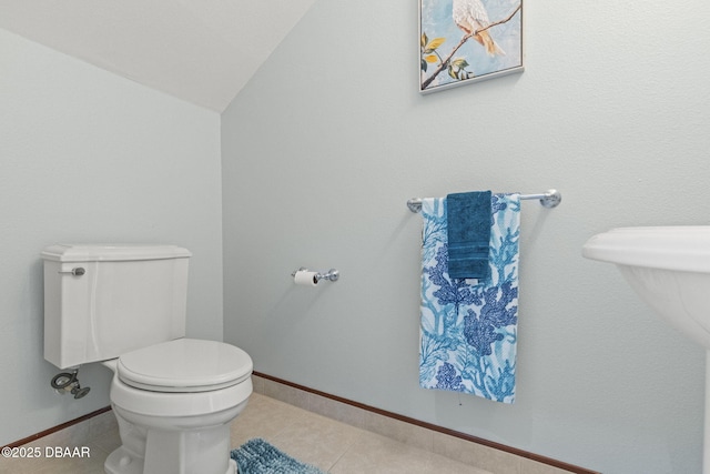 4210 S Peninsula Dr, Port Orange, FL 32127 - bathroom featuring toilet, tile patterned flooring, baseboards, and lofted ceiling