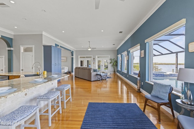 4210 S Peninsula Dr, Port Orange, FL 32127 - living area with ceiling fan, light wood finished floors, recessed lighting, crown molding, and baseboards