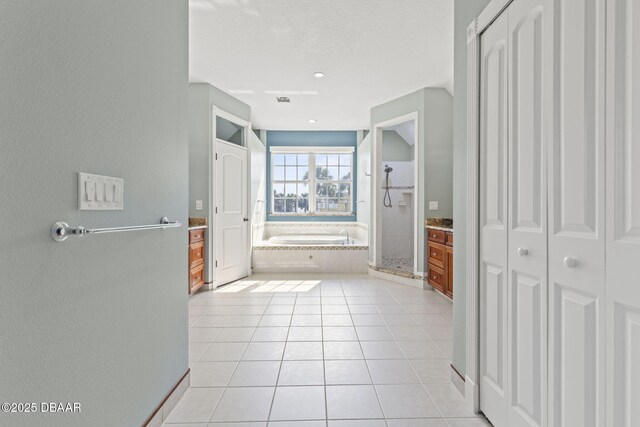 4210 S Peninsula Dr, Port Orange, FL 32127 - bathroom with a closet, a bath, tile patterned floors, an enclosed shower, and a textured ceiling