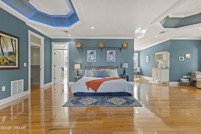 4210 S Peninsula Dr, Port Orange, FL 32127 - bedroom featuring ornamental molding, wood finished floors, baseboards, recessed lighting, and a sink