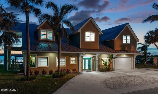 4210 S Peninsula Dr, Port Orange, FL 32127 - view of front of property featuring driveway, a standing seam roof, and metal roof
