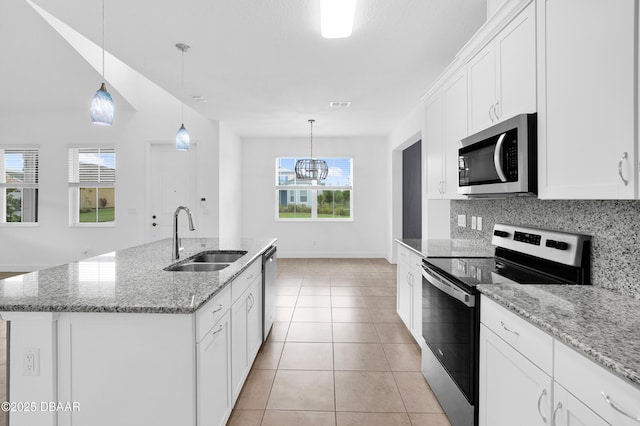 623 Margaritaville Ave, Daytona Beach, FL 32124 - kitchen featuring stainless steel appliances, decorative backsplash, white cabinetry, light tile patterned flooring, and light stone counters
