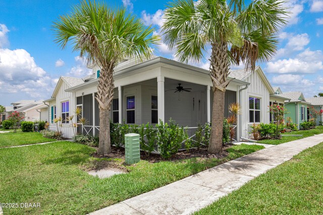 623 Margaritaville Ave, Daytona Beach, FL 32124 - view of property exterior with ceiling fan, board and batten siding, and a yard
