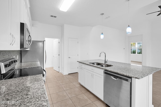 623 Margaritaville Ave, Daytona Beach, FL 32124 - kitchen featuring appliances with stainless steel finishes, white cabinetry, a center island with sink, and light tile patterned flooring