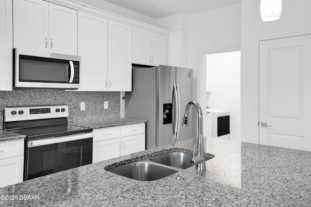 623 Margaritaville Ave, Daytona Beach, FL 32124 - kitchen featuring stainless steel appliances, white cabinetry, dark stone countertops, and backsplash