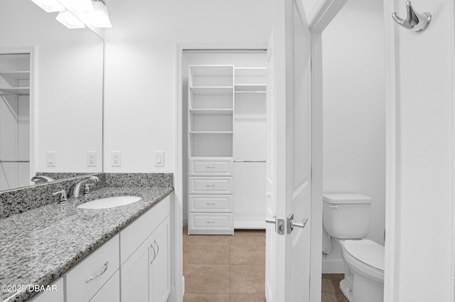 623 Margaritaville Ave, Daytona Beach, FL 32124 - bathroom with vanity, tile patterned floors, and a spacious closet