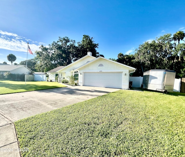 ranch-style house featuring a garage and a front yard