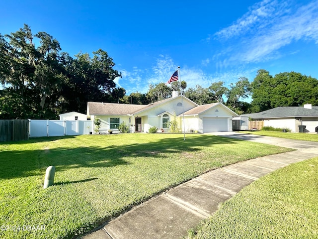 single story home featuring a garage and a front lawn