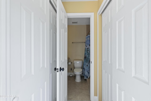 bathroom with tile patterned flooring and toilet